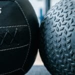 generate an image for the topic of Soft Medicine Ball vs. Hard Slam Ball Training Applications